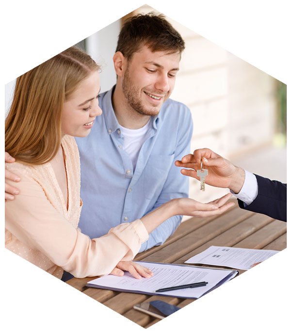 Young couple getting keys to property