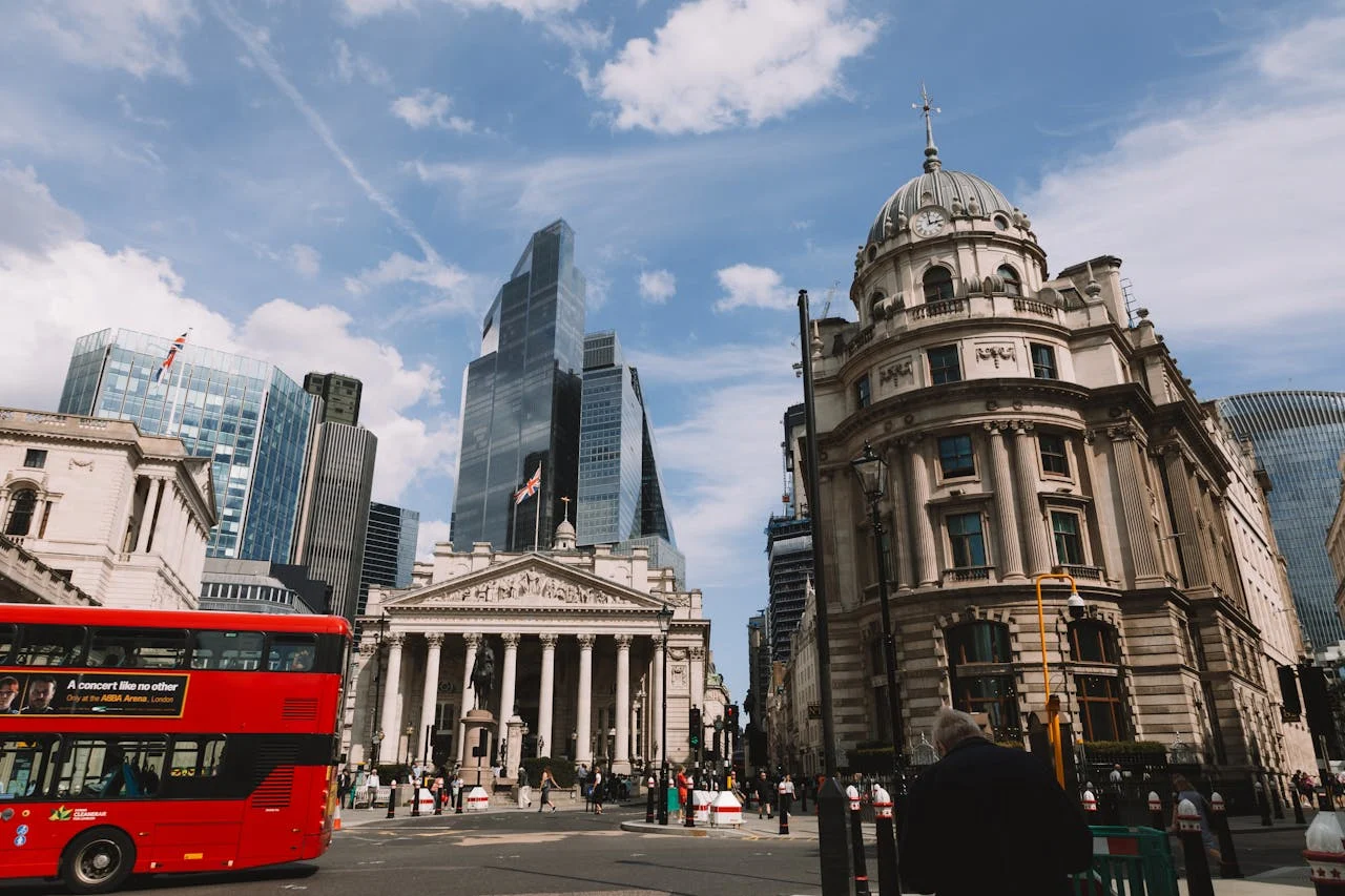 Bank of England with London red bus driving by
